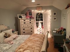 a bedroom decorated for christmas with lights and teddy bears