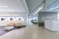 the interior of a car dealership with modern furniture