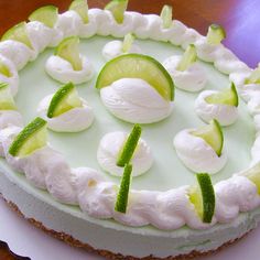 a cake with cucumber and lime slices on it