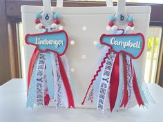 two red, white and blue ribbons are attached to the back of a bag that says linebrogger campbell