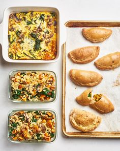 four containers filled with food sitting on top of a white counter next to each other