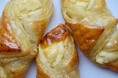 four pastries sitting on top of a white plate