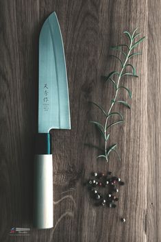 a knife and some berries on a table