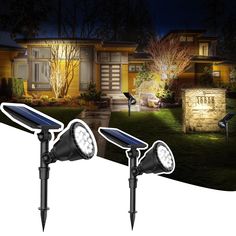 two solar powered lights in front of a house at night with the light turned on