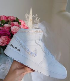 DESCRIPTION: Welcome! I've had years of experience in creating unique custom sneakers, but recently have discovered a newfound passion for designing special sneakers for brides! Reflecting on my wedding, I remember the agony and pain of wearing uncomfortable shoes that didn't match my dress.  Recently, one of my best friends was getting married and was facing the same issue, so I decided to surprise her with a custom pair of sneakers that would ensure she was comfortable enough to dance all nigh Sneakers For Bride, Jordan Aesthetic, Wedding Sneakers For Bride, Jordan Air Max, Nike Air Jordan Mid, Bride Sneakers, Dream Wedding Shoes, Bridal Sneakers, Pearl Bride