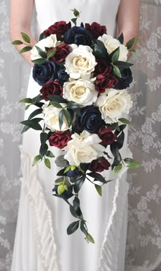 a bridal holding a bouquet of red, white and blue flowers