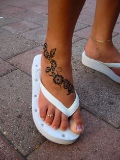 a woman's foot with a tattoo on it