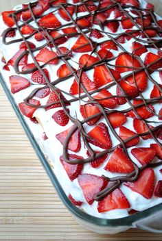 chocolate and strawberries are arranged in the shape of a heart on a sheet cake