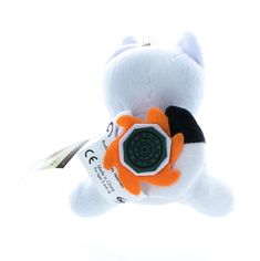 a white teddy bear with an orange and black flower on it's back end