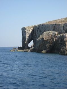 a rock formation in the middle of water