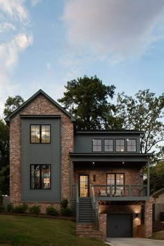 a large brick house with stairs leading up to it