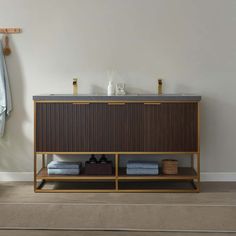 a bathroom with a sink, towel rack and rug on the floor in front of it