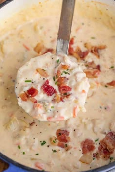 a ladle full of creamy potato soup with bacon