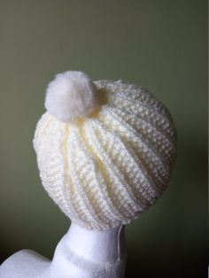 Lovingly handmade in the beautiful Lincolnshire Wolds, where walking and the outdoors are an integral part of life, this gorgeous Beanie Hat has been hand knitted seamlessly, using a premium quality, Aran yarn in winter white (cream). Warm and cosy, this hat features a classic ribbed design with a fluffy pompom that will add a touch of style and luxury to any outfit whatever the occasion. One size - 36cm / 14ins around brim x 26cm / 10.25ins tall Wool is 100% Acrylic - non-itchy, soft and totally vegan friendly. Machine washable at 40. Cool tumble dry. Your Hat will be carefully wrapped in white tissue paper secured with black satin ribbon - my packaging is responsibly and sustainably sourced and recyclable where possible. If you would prefer another colour please just send me a message. T White Beanies, Satin Noir, Stocking Filler Gifts, Autumn Vibes, Matching Accessories, Stocking Filler, Stocking Fillers, Winter White, Beanie Hat