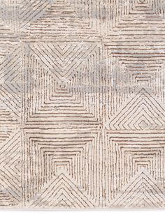 an area rug with various lines and shapes on the ground, in neutral tones that appear to be made out of wool