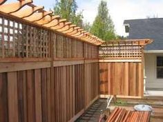 a wooden fence next to a house