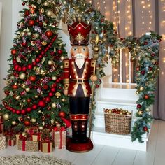 a nutcracker standing next to a christmas tree