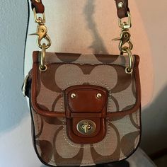 Coach Canvas Mini Purse In Pristine Condition. Never Used And Would Love To Adorn You With This Stylish Accessory. Purse Is 7” Tall X 7” Wide. Smoke Free Home. Reasonable Offers Considered. Quick To Respond To Questions And Ship Packages. Brown Coach Shoulder Bag With Removable Pouch, Coach Shoulder Bag With Gold-tone Hardware For Travel, Coach Brown Wristlet With Zipper Closure, Coach Shoulder Bag With Removable Pouch For On-the-go, Brown Coach Bags With Silver-tone Hardware, Shipping Packaging, Bags Coach, Mini Purse, Coach Bags