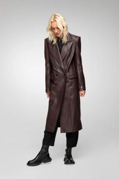 Women's Leather Trench Coat In Coffee Brown Indulge in timeless elegance with this women's leather trench coat in coffee brown. Crafted from genuine sheepskin leather with a semi-aniline finish, this long coat features a sophisticated notch collar and button closure. The stylish design is enhanced with zipper cuffs, offering a modern touch. Practicality meets luxury with one inside pocket and two side pockets. Perfect for any occasion, this coat adds a refined touch to your wardrobe. Outer Shell: Genuine Leather Leather Type: Sheepskin Leather Finish: Semi-aniline Feature: Long Coat Closure Style: Button Collar Style: Notch Cuffs Style: Zipper Inside Pockets: One Outside Pockets: Two Side Pocket Color: Coffee Brown Leather Trench Coat Woman, Leather Shorts Women, Short Leather Skirts, Leather Jumpsuit, Long Leather Coat, Shearling Vest, Sheepskin Jacket, Studded Jacket, Distressed Jacket