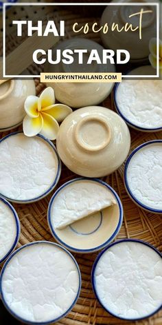 some white and blue dishes on top of a wicker basket with flowers in the background