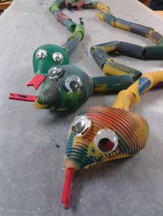 three paper mache birds sitting on top of a table