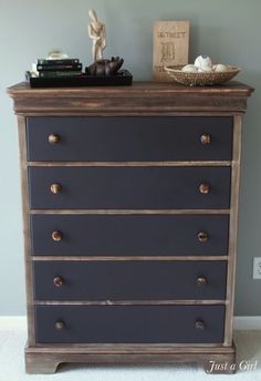 an old dresser has been painted dark blue