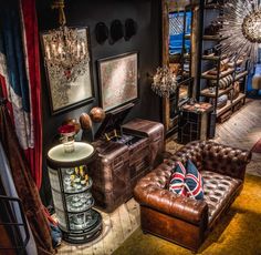 a living room filled with furniture and pictures on the wall next to a lamp fixture