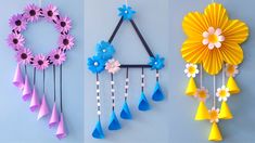 three different types of paper flowers hanging on the wall