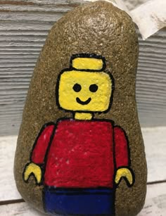 a rock with a lego man painted on it