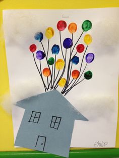 a paper house with colorful balloons in the shape of a house