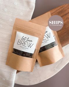 two bags of coffee beans sitting on top of a white plate