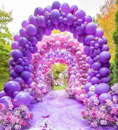 purple and pink balloon arch with flowers