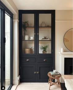 a living room filled with furniture and a fire place in front of a glass door