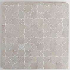 an abstract tile design in grey and white colors on a wall or floor with no one around it