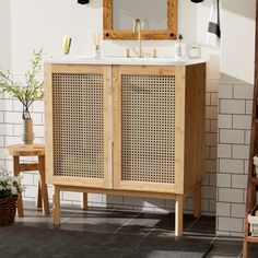 a bathroom with a sink, mirror and shelving unit on the floor in front of it