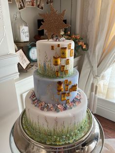 a three tiered cake sitting on top of a table