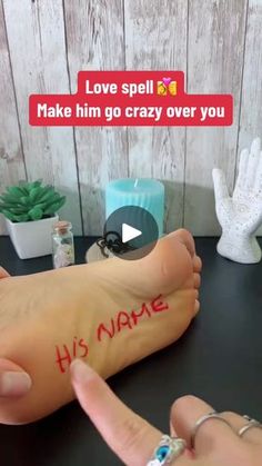 someone has written his name on their foot and is pointing to the side with both hands