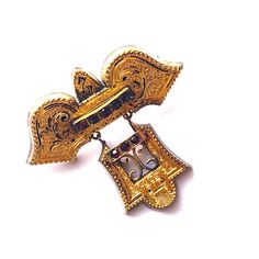 I don't typically buy gold filled jewelry but I could not pass up this Victorian beauty! This brooch would be an amazing addition to a coat lapel, wedding ensemble, or it could be pinned to a velvet ribbon and worn as a pendant! This is an early Victorian piece with amazing detail. Its about 40mm long by 40mm wide at the widest point. There are 8 rose cut red garnets about 2mm in diameter each. The face has an engraved floral design and texture. The pin on the back is likely a replacement but it Lapel Wedding, Statement Engagement Ring, Victorian Beauty, Moissanite Engagement Ring Halo, Victorian Gold, Gold Engraving, Silver Pin, Bridal Bands, Deco Jewelry