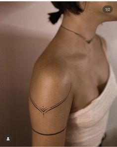 a woman with a tattoo on her shoulder