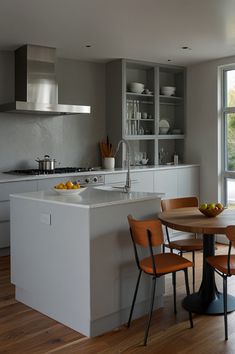 a kitchen with a table and chairs next to an open window that looks out onto the outside