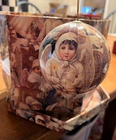 a glass ornament hanging from a wooden table