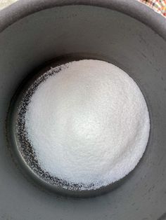 a bowl filled with sugar sitting on top of a table