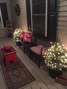 a porch decorated for christmas with lights and decorations