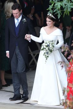 the bride and groom are holding hands