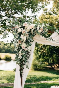 a wedding arch with flowers and greenery