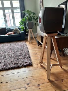 a living room filled with furniture and a flat screen tv on top of a wooden stand