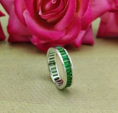 "Step into a world of elegance with our exquisite Elegant Green Emerald Eternity Band - a mesmerizing array of baguette-cut emerald stones gracefully encircling the band, symbolizing eternal love and prosperity. The brilliant green hue of the emeralds  making it an ideal choice for a May birthday gift or as a cherished emerald stacking ring or as everyday ring Handcrafted Crafted 925 Sterling Silver, this 4.50 MM band resonates with grace and allure. The 2.60 Ct baguette-cut simulated diamond (cubic zirconia) stones sparkle brilliantly. Elevate your style with our Elegant Green Emerald Eternity Band. Order now and experience the enchanting magic of this unique piece, crafted with you in mind. 💍🌟 ✥ Ring Details    Metal Purity   :   925 Sterling Silver Plating        :   WG / YG / RG Plat Emerald Eternity Band, Baguette Wedding Band, May Birthstone Rings, Cleaning Silver Jewelry, May Birthday, Emerald Cut Moissanite, Stacking Bands, May Birthstone, Everyday Rings