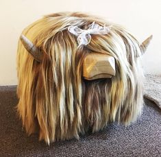 a stuffed animal with long hair and horns