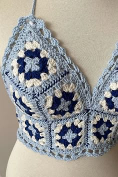 a blue and white crocheted bralet on a mannequin