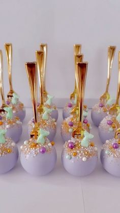 there are many purple candys with gold decorations on them